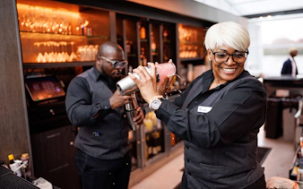 Bartenders preparing drinks on the Premier Bottomless Mimosa Brunch Cruise in Washington DC.