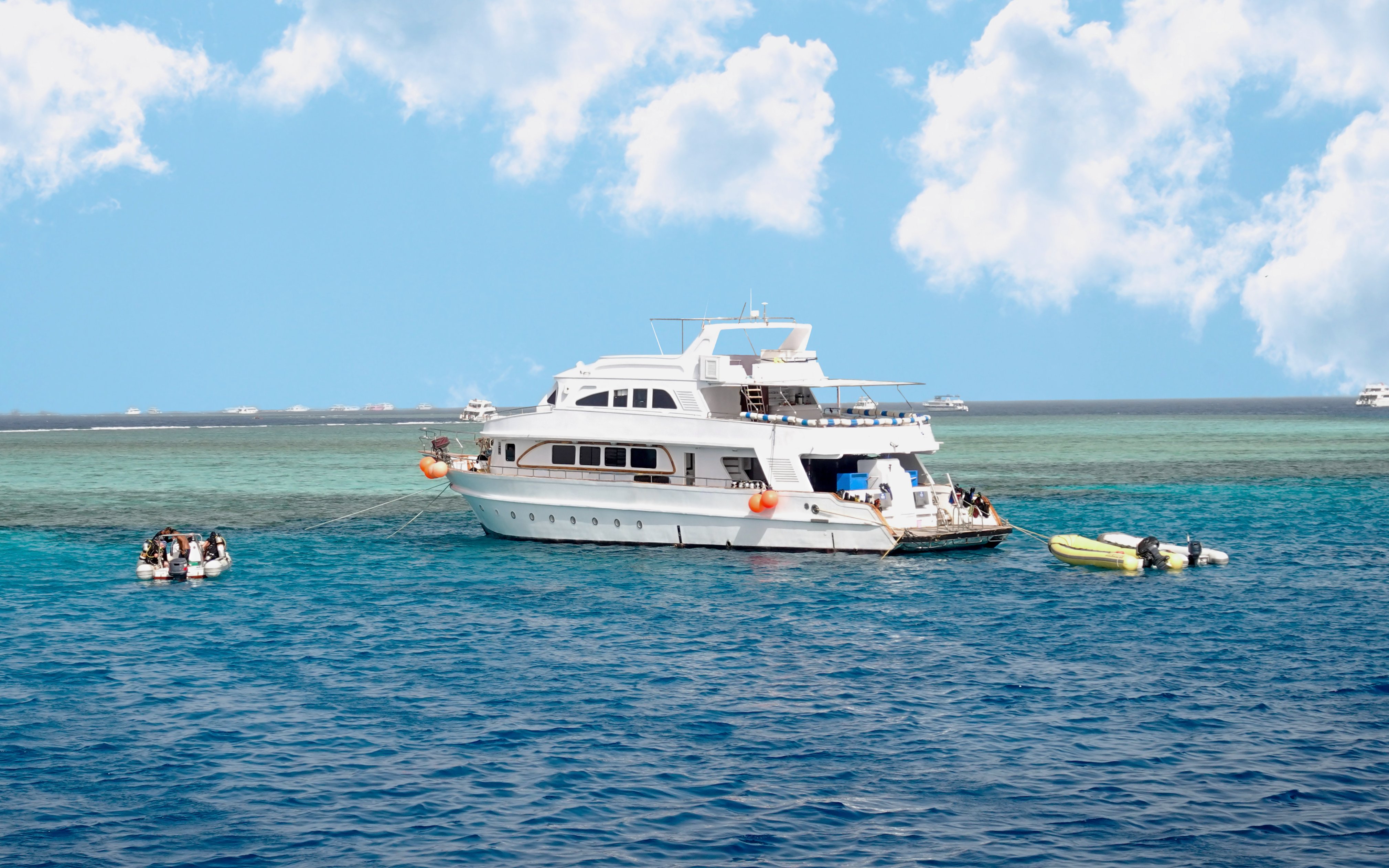 Diving boat anchored near coral reef island in Hurghada, Egypt.
