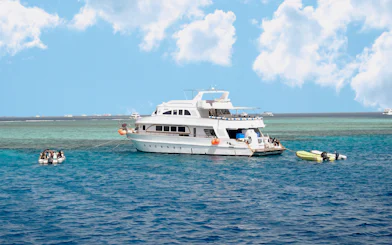 Diving boat anchored near coral reef island in Hurghada, Egypt.