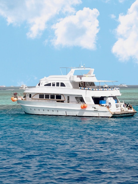 Diving boat anchored near coral reef island in Hurghada, Egypt.