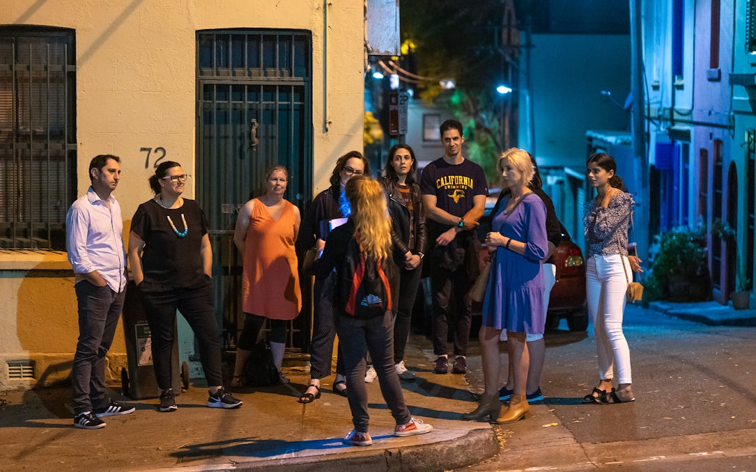 Group on Sydney's Razor Gang True Crime Tour at night.