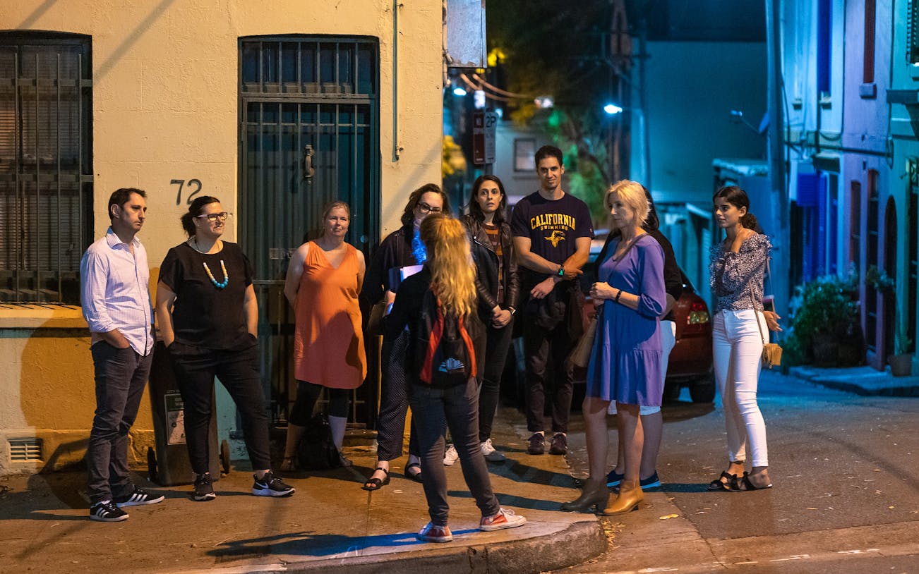 Group on Sydney's Razor Gang True Crime Tour at night.