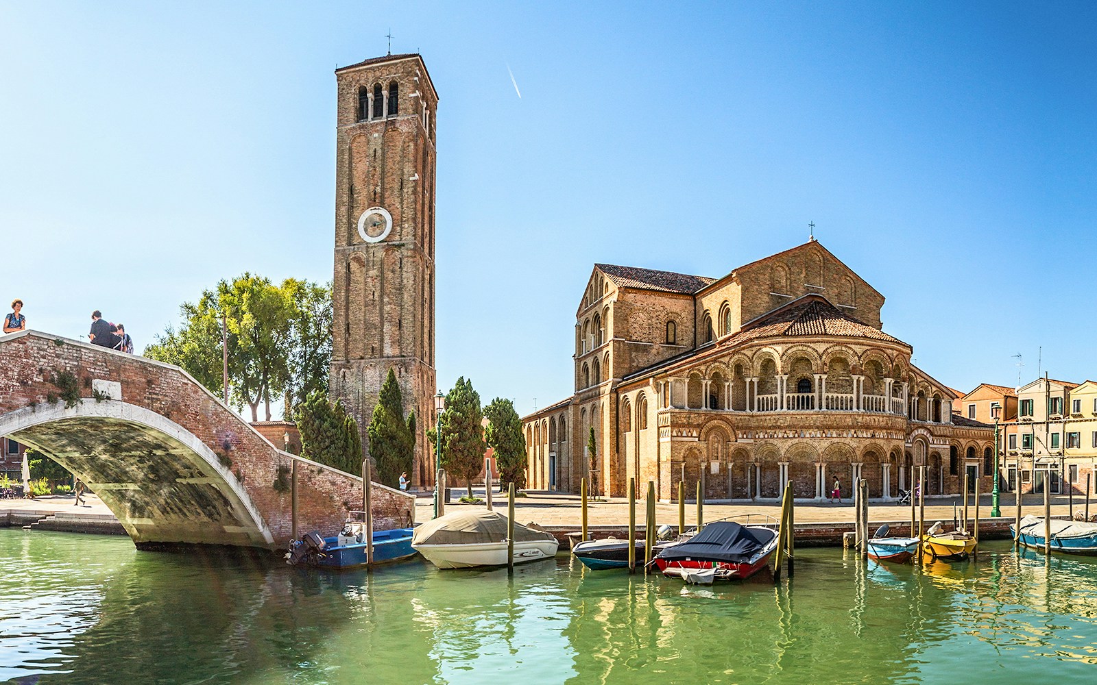 Murano's Basilica dei Santi Maria e Donato with boats on the canal, Venice tour.