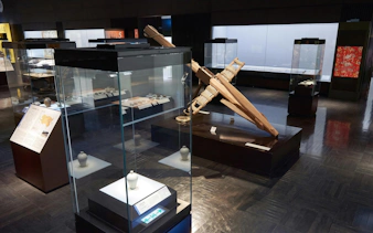 Installation of historical artifacts at Kyushu National Museum exhibit hall.