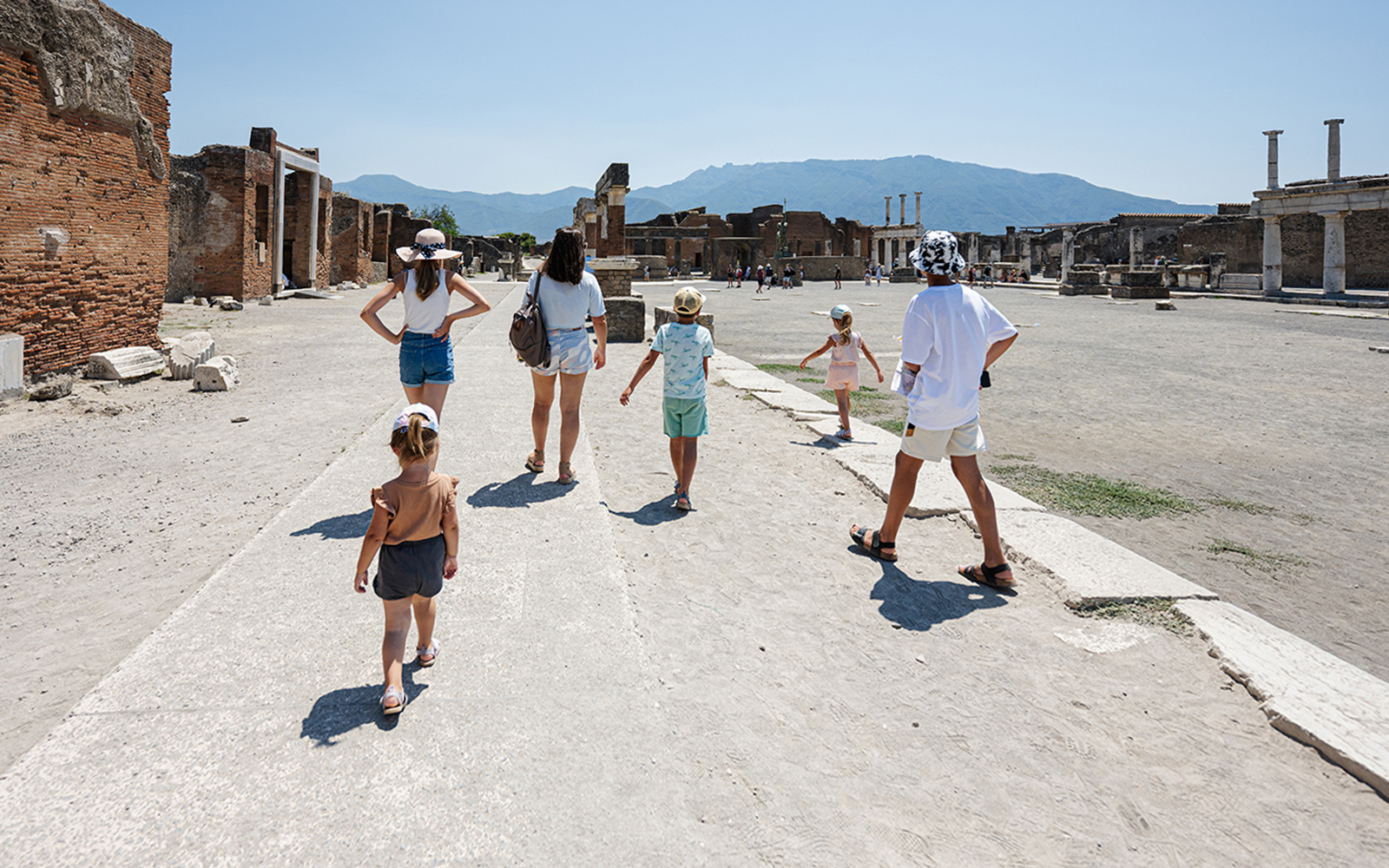 Tourists exploring ancient ruins in Pompeii, Italy on the Pompeii Express tour.