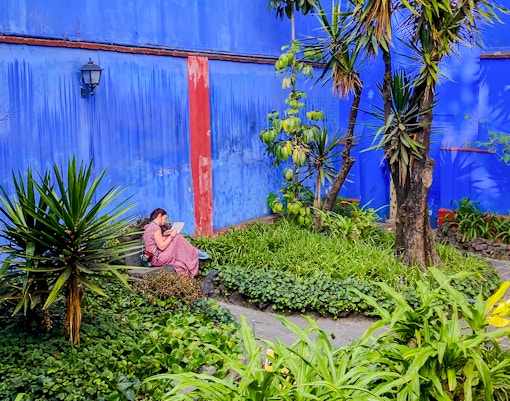 Frida Kahlo Museum exterior with visitors in Coyoacán, Mexico City.