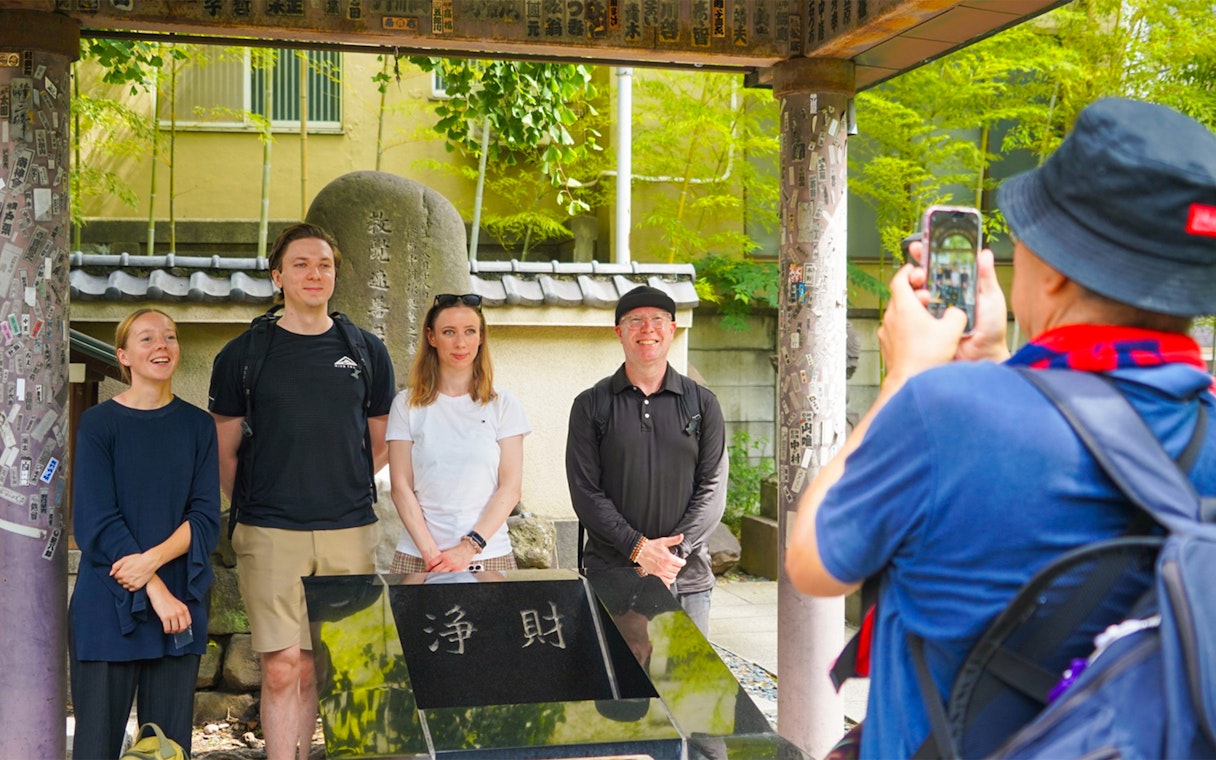 Tourists posing for a photo at a historic site in Ryogoku, Tokyo.