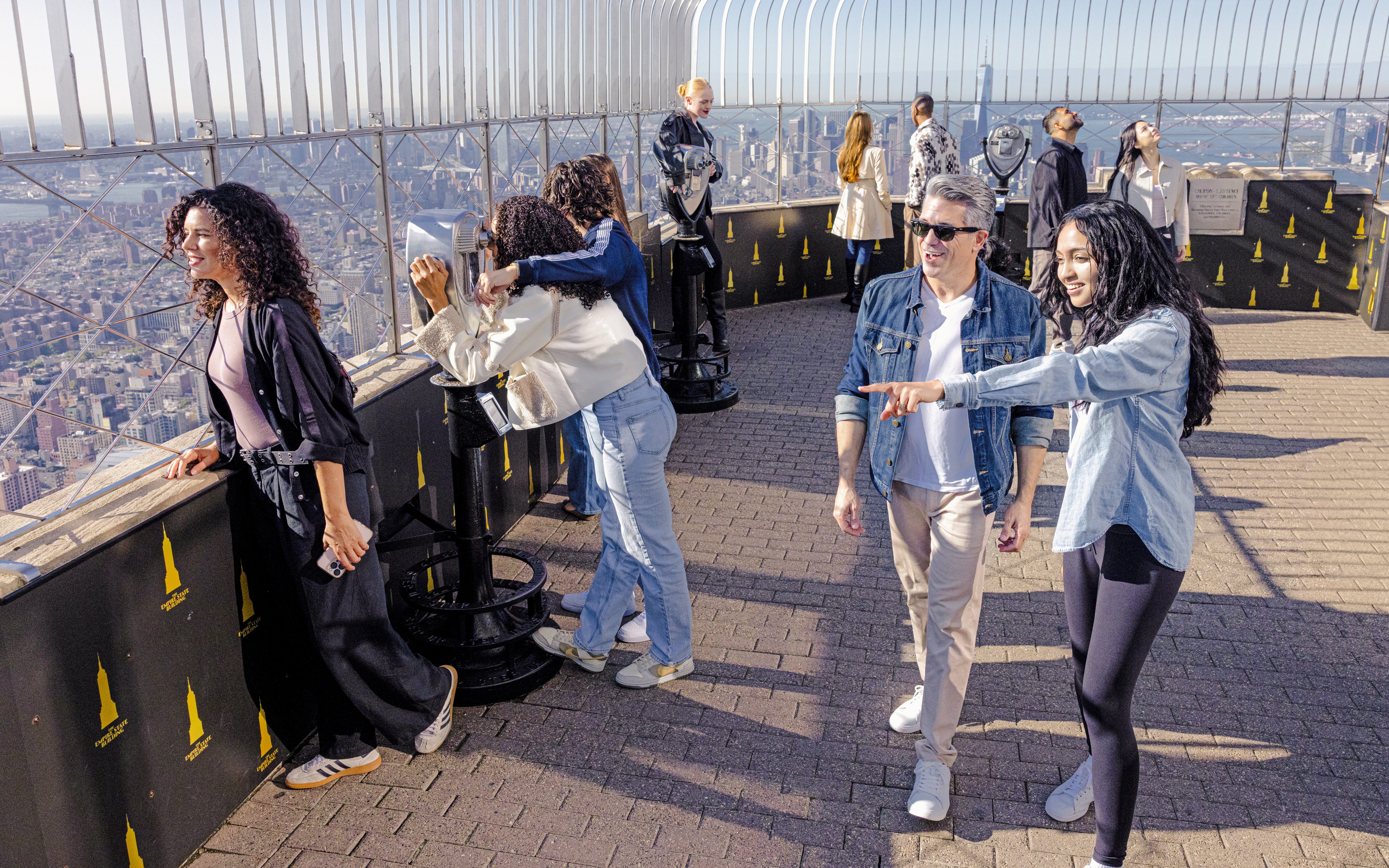 Guests enjoying the view from the Empire State Building observation deck in New York City.