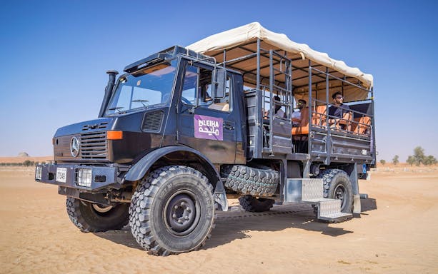 UniMog vehicle on guided tour at Mleiha Archeological Centre, UAE desert.