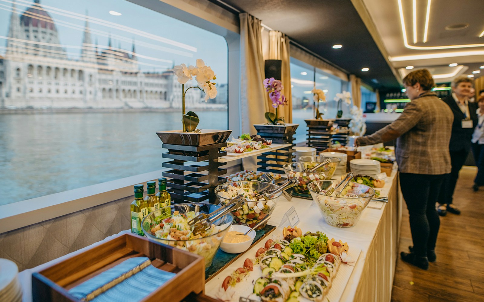 Buffet spread on New Year's Eve dinner cruise with river view in Budapest.