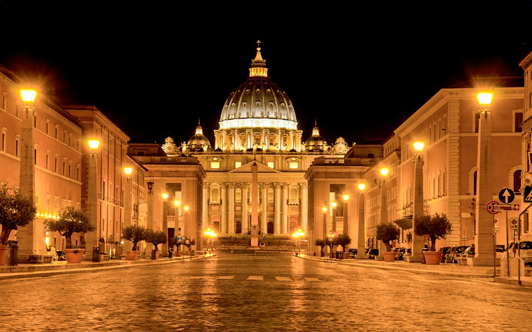 St. Peter's Basilica illuminated at night during a Rome night tour.