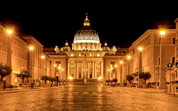 St. Peter's Basilica illuminated at night during a Rome night tour.