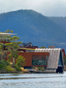 Exterior view of MONA, Museum of Old & New Art, with surrounding landscape in Hobart, Tasmania.
