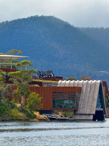 Exterior view of MONA, Museum of Old & New Art, with surrounding landscape in Hobart, Tasmania.