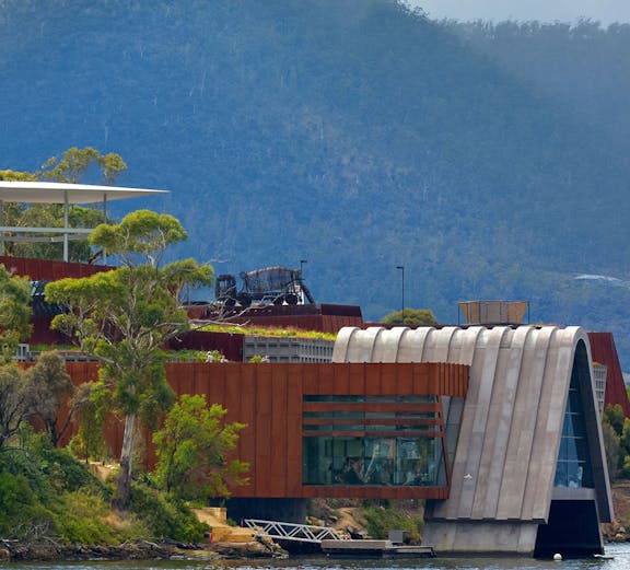 Exterior view of MONA, Museum of Old & New Art, with surrounding landscape in Hobart, Tasmania.