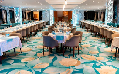 Elegant dining setup on a Nile dinner cruise in Cairo with decorated tables and chairs.