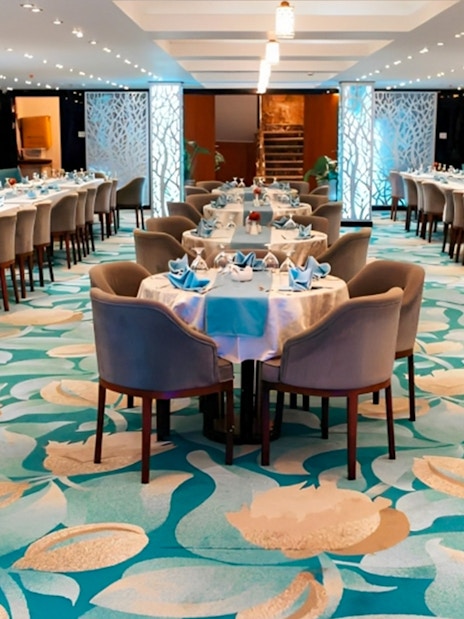 Elegant dining setup on a Nile dinner cruise in Cairo with decorated tables and chairs.