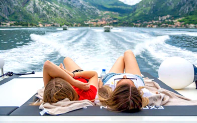 Guests relaxing on a speedboat with views of Kotor Bay during Blue Cave tour.