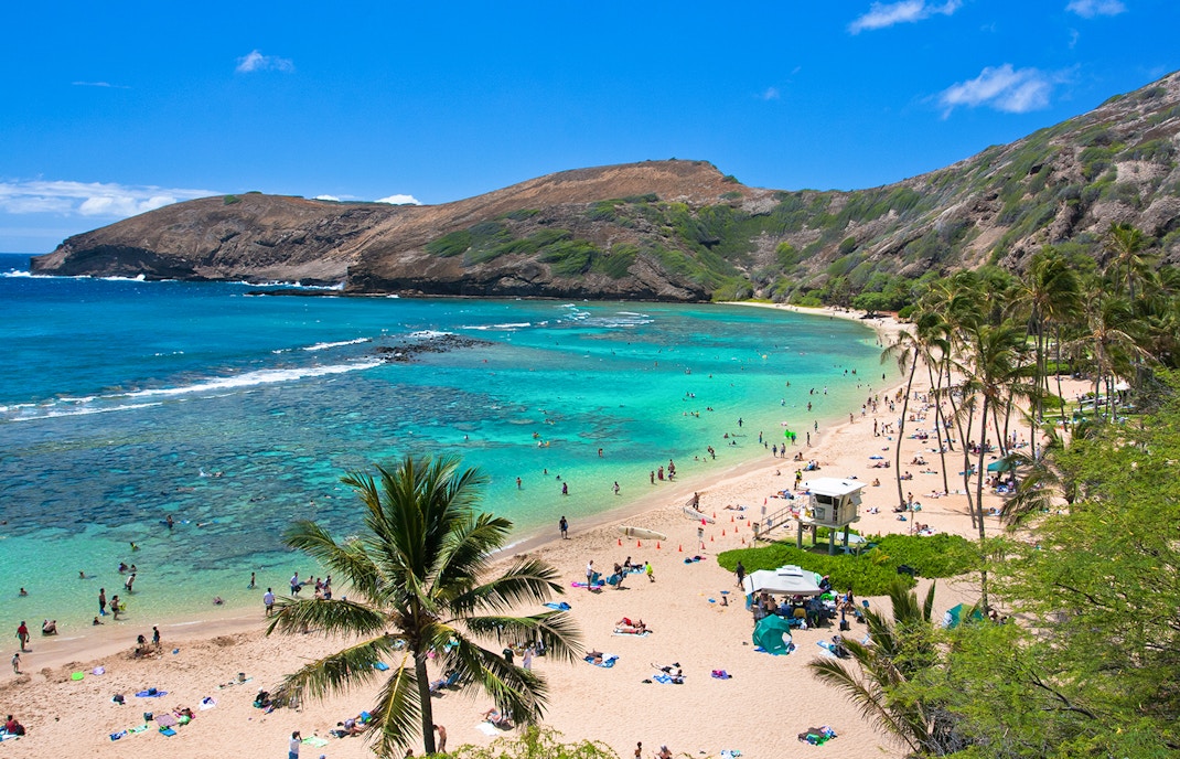 Hanauma Bay beach with visitors swimming and relaxing, Oahu, Hawaii.