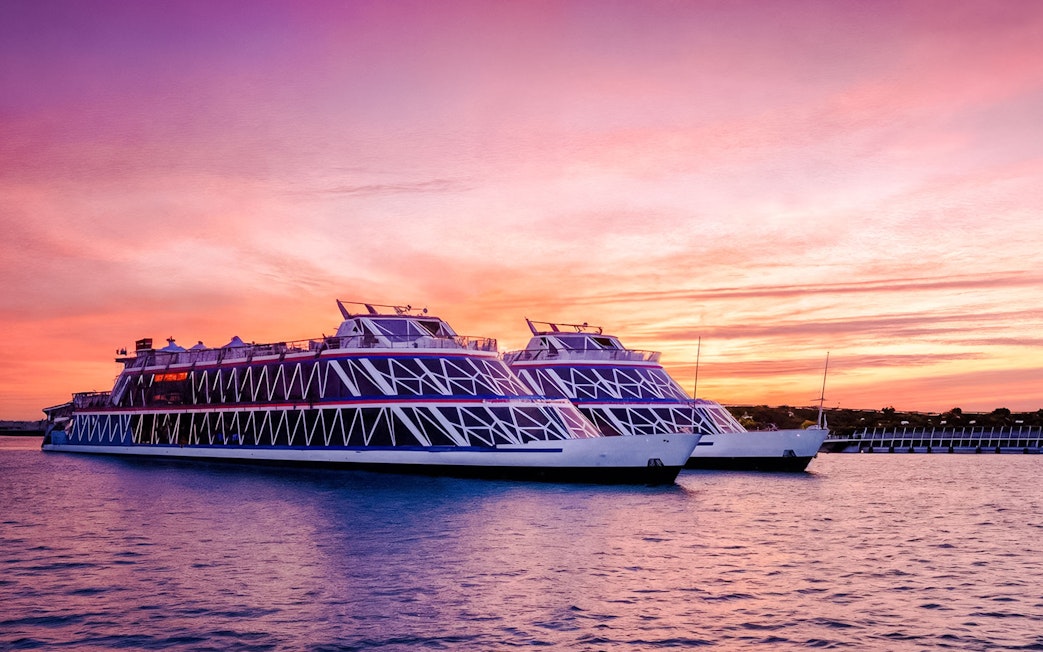 Nile Crystal dinner cruise ships on the river at sunset.