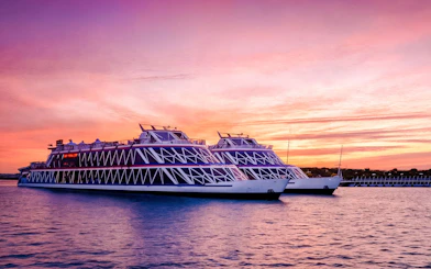 Nile Crystal dinner cruise ships on the river at sunset.