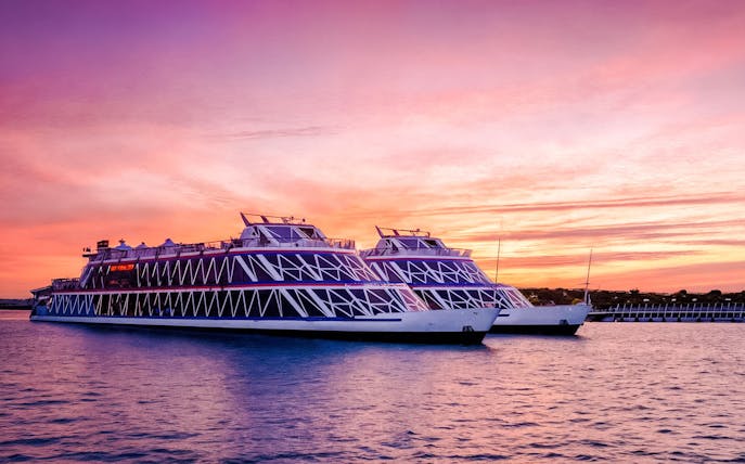 Nile Crystal dinner cruise ships on the river at sunset.