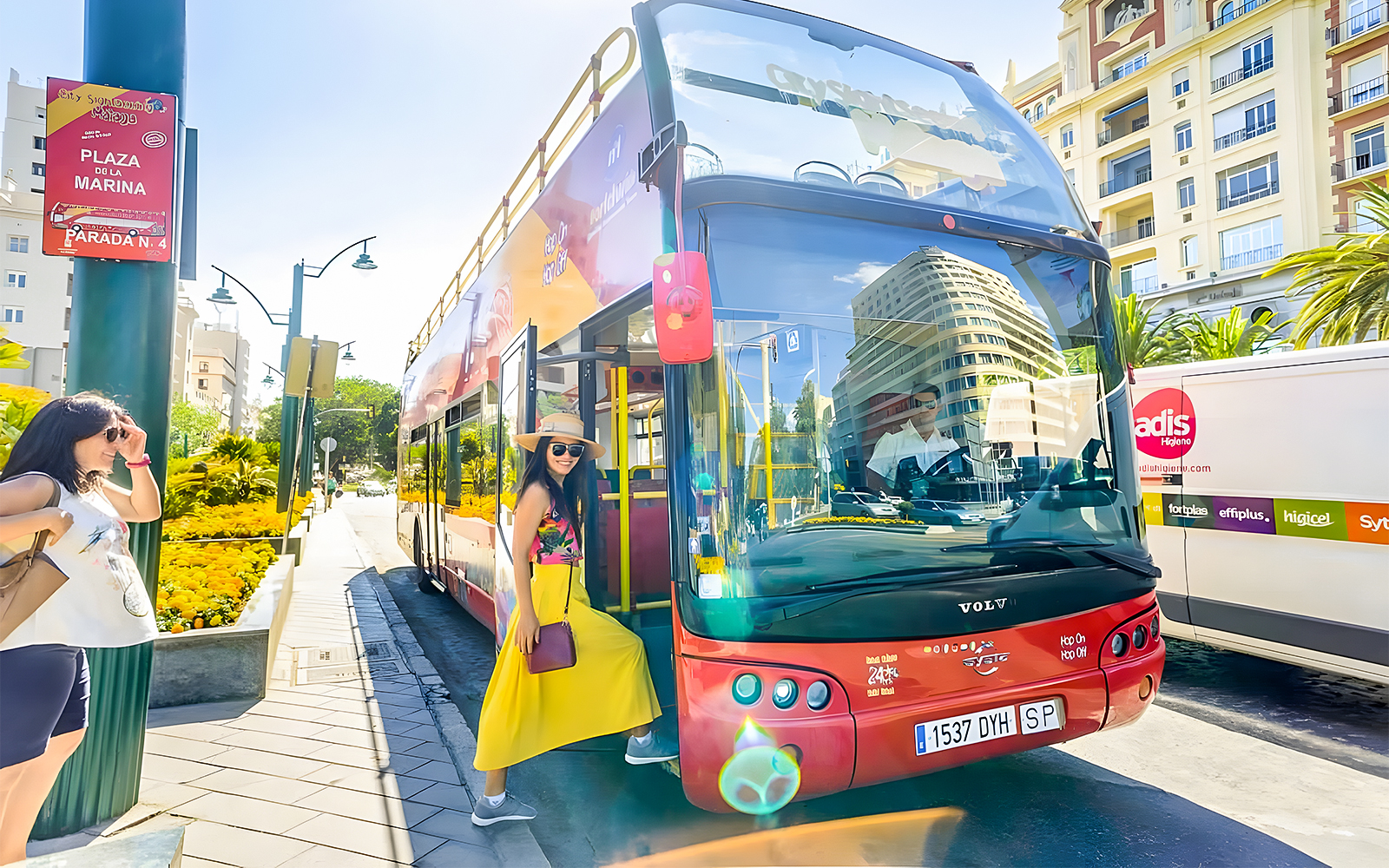 Woman boarding City Sightseeing hop-on hop-off bus at Plaza de la Marina, Malaga.