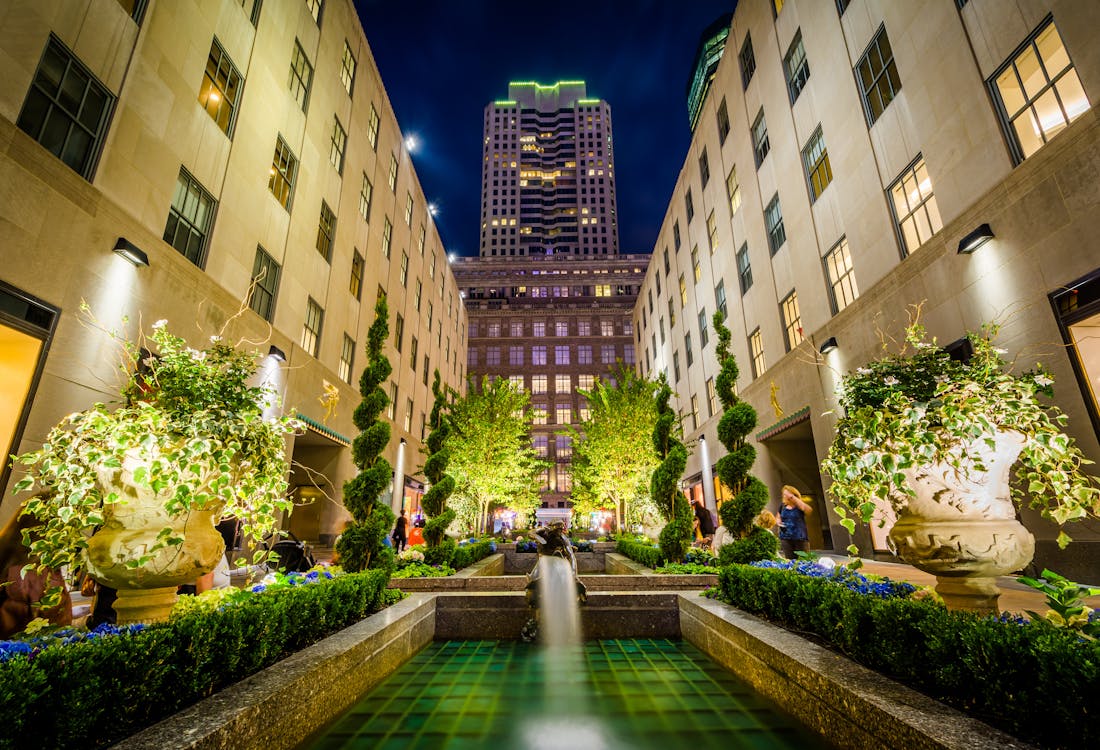 Channel Gardens at Rockefeller Center, New York City, illuminated at night with fountains and greenery.