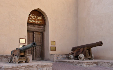 Two bronze cannons at the entrance of Nizwa Fort, Oman.