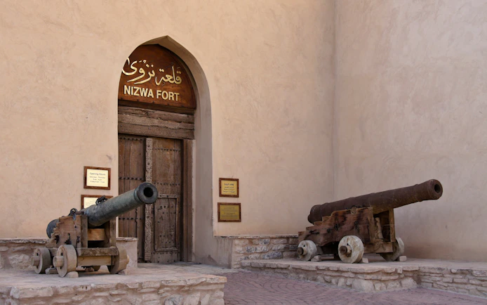 Two bronze cannons at the entrance of Nizwa Fort, Oman.