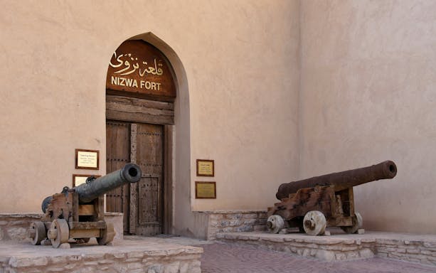 Two bronze cannons at the entrance of Nizwa Fort, Oman.