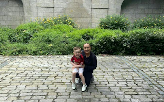 Child and adult on cobblestone path in Dublin garden, part of Kid Quest Lost Senses game.