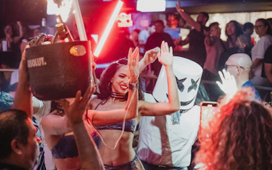 Partygoers dancing at Mandala Nightclub Cancun with vibrant lights and lively atmosphere.