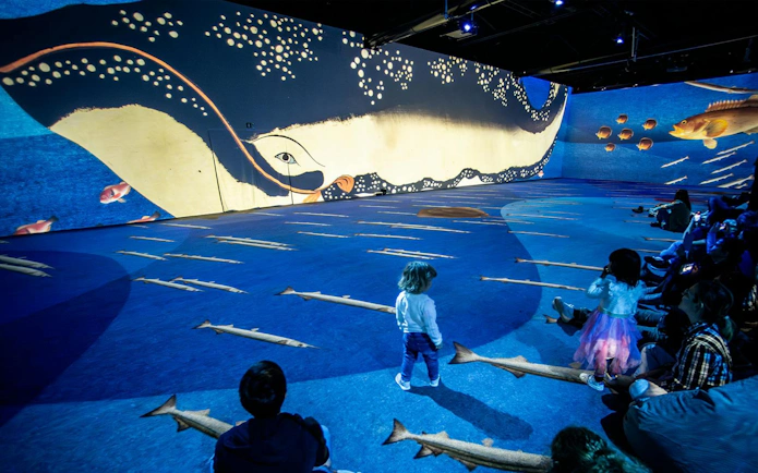Children exploring immersive ocean-themed art installation in Rotterdam.