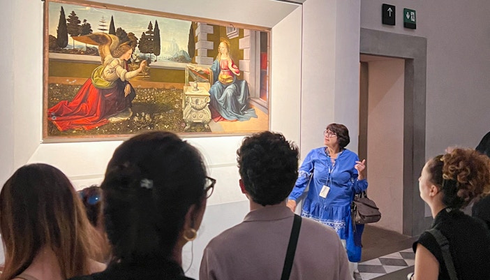 Visitors exploring art exhibits inside the Uffizi Gallery, Florence, during a private tour.