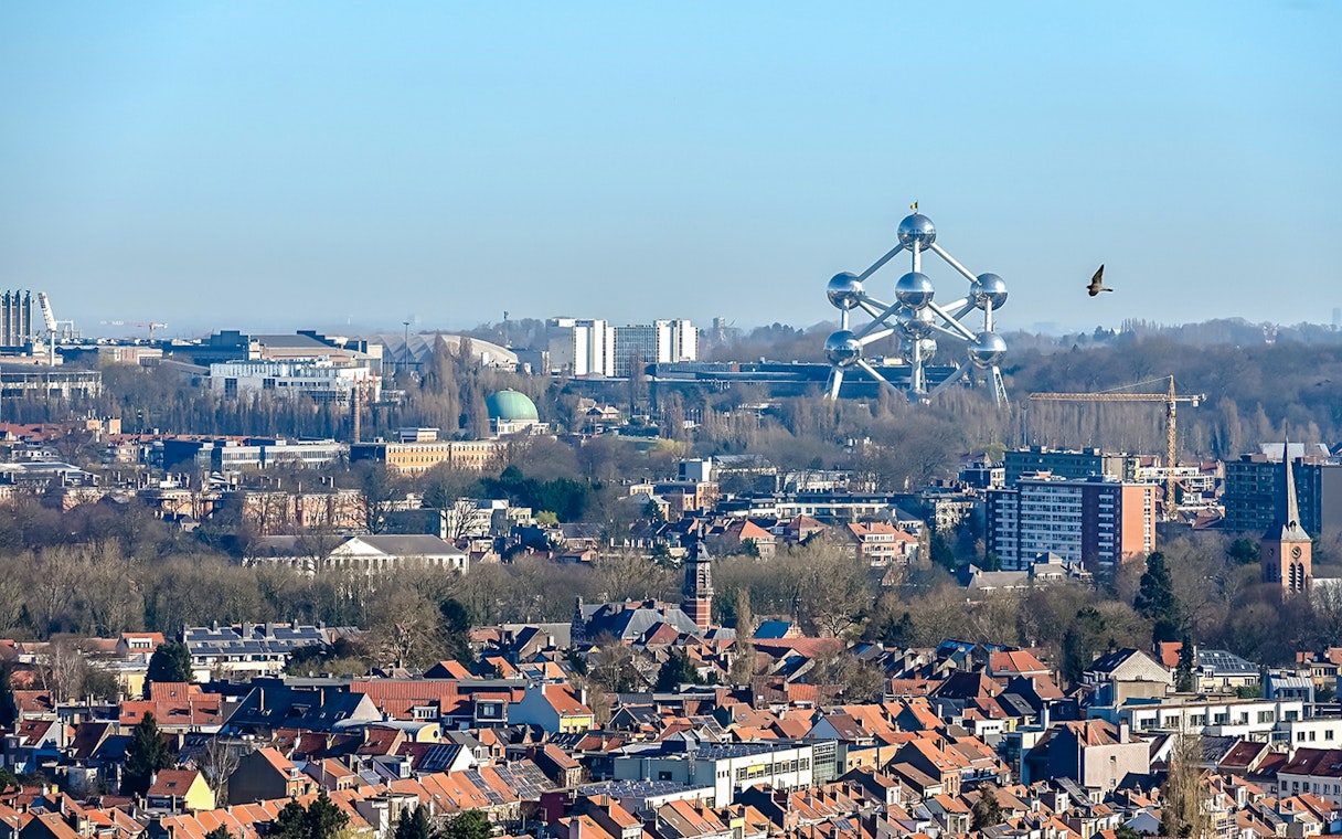 Atomium in Brussels skyline with surrounding cityscape.