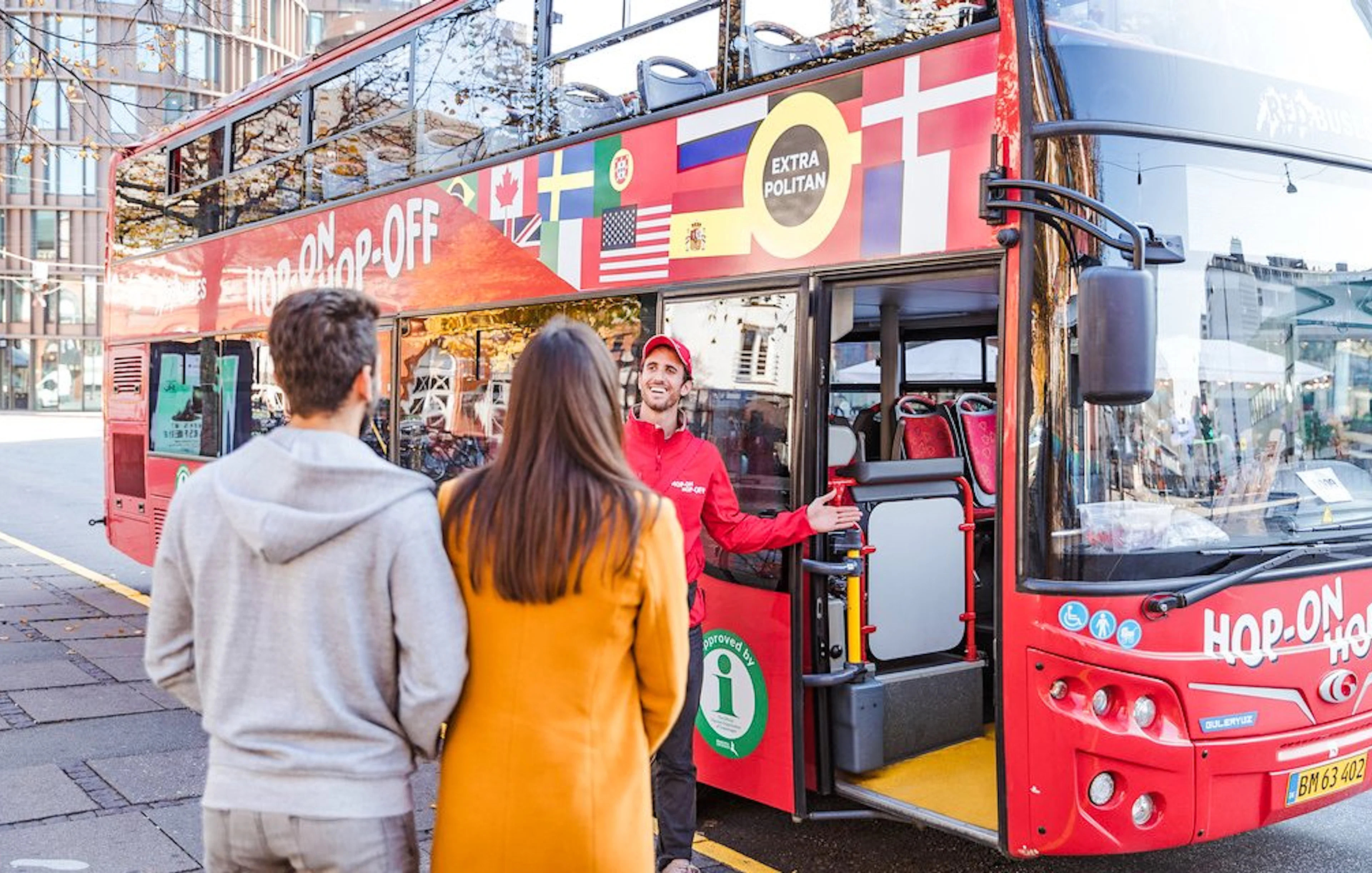 Copenhagen Hop-On Hop-Off bus with guide welcoming tourists.