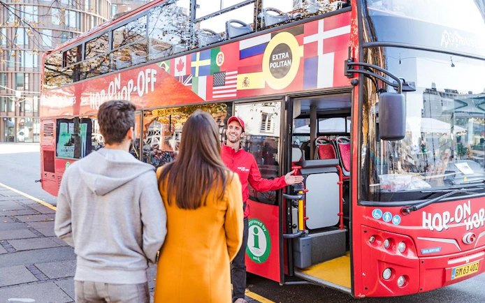 Copenhagen Hop-On Hop-Off bus with guide welcoming tourists.