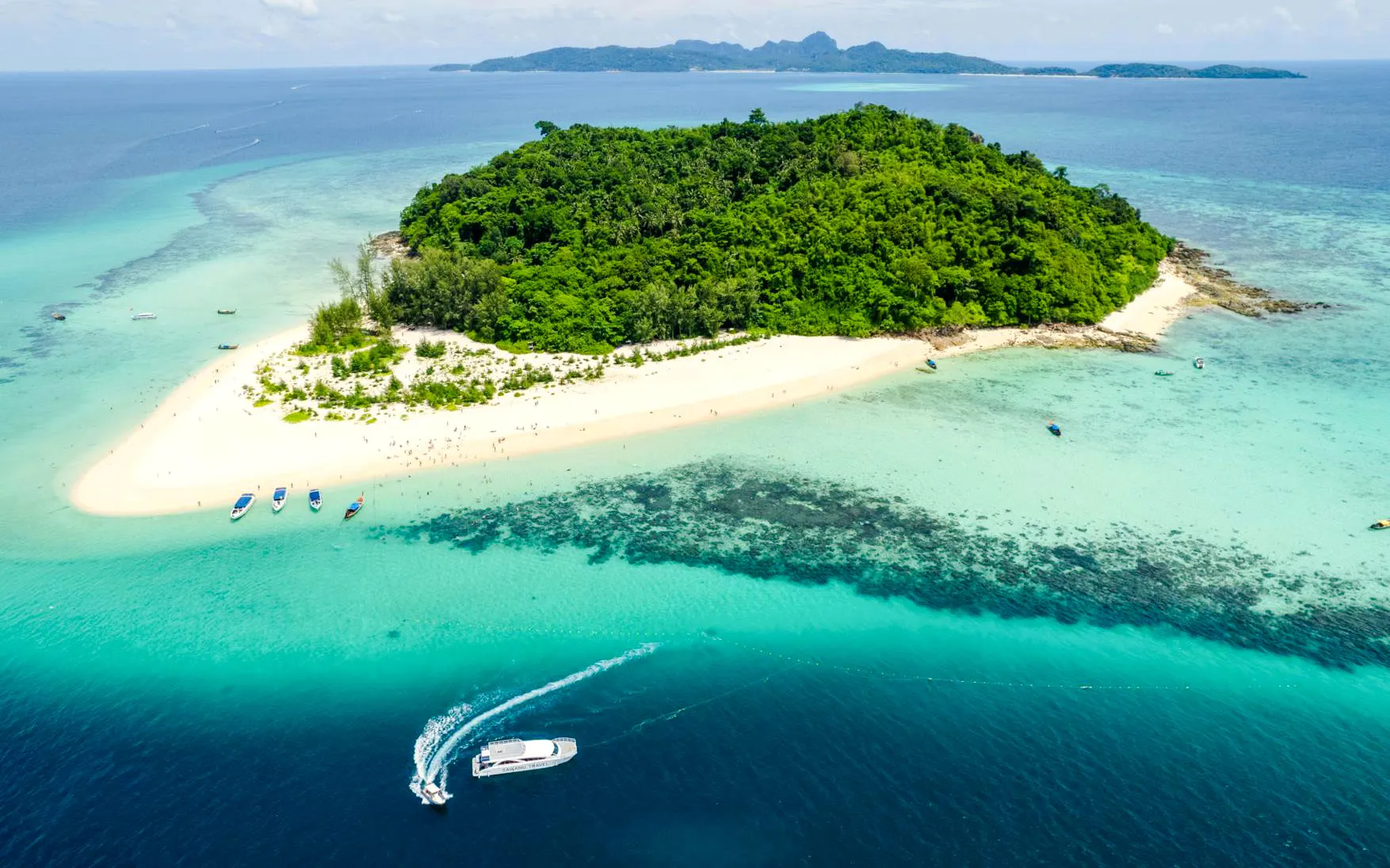 Aerial view of Bamboo Island with lush greenery and sandy beaches, Phuket catamaran tour.