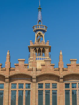 CaixaForum Barcelona building with ornate brickwork and blue-tiled spire.