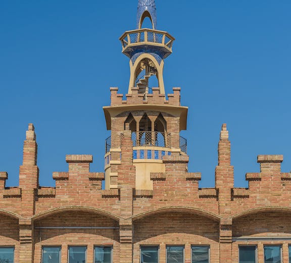 CaixaForum Barcelona building with ornate brickwork and blue-tiled spire.