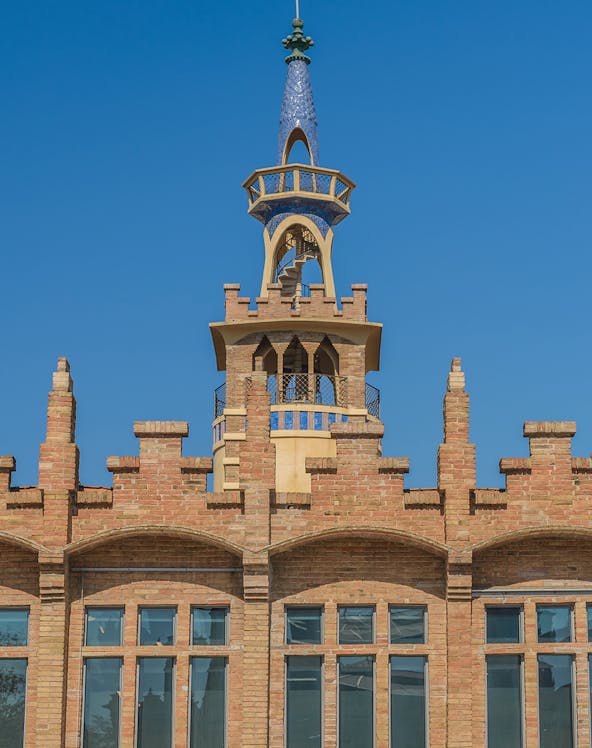 CaixaForum Barcelona building with ornate brickwork and blue-tiled spire.