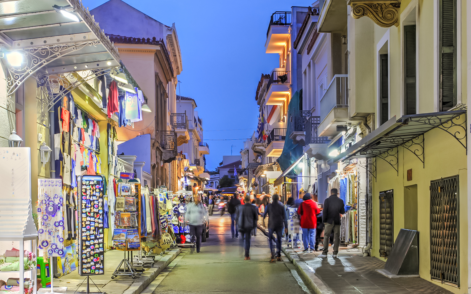 Bustling street in Plaka, Athens, Greece with shops and people walking.