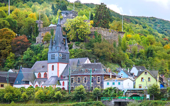 Rhine Valley village with church and castle ruins during day trip from Frankfurt.
