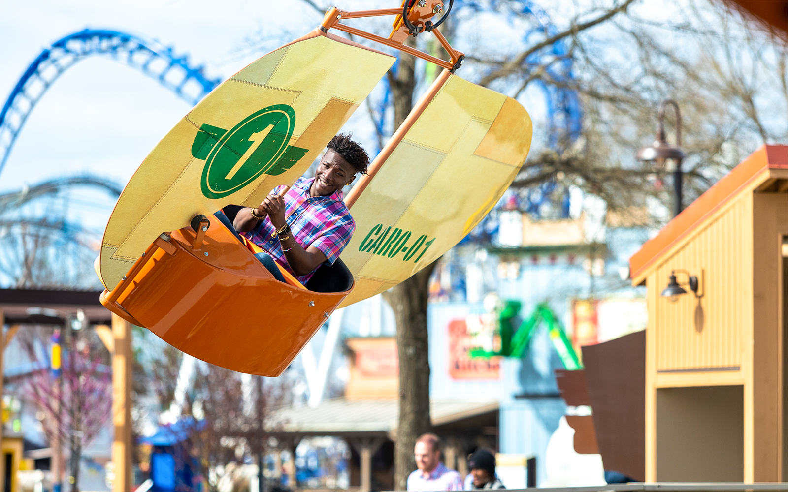 Mountain Gliders ride at Six Flags Carowinds with a person enjoying the experience.