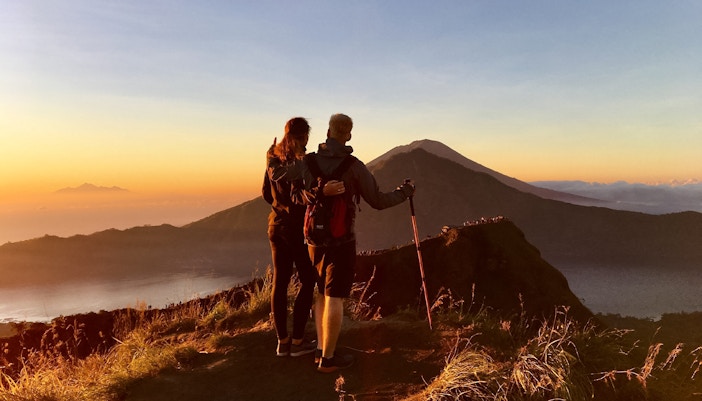 Couple looking at Mount Batur on a sunrise trek