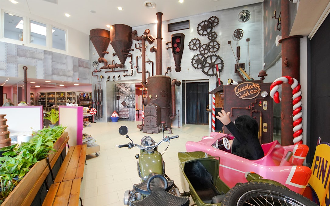 Steampunk-themed exhibit with gears and pipes inside Chocotopia, Prague.