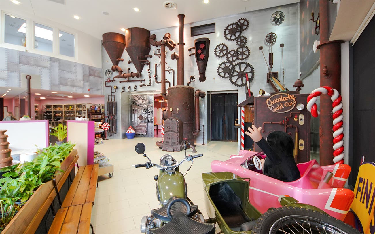 Steampunk-themed exhibit with gears and pipes inside Chocotopia, Prague.