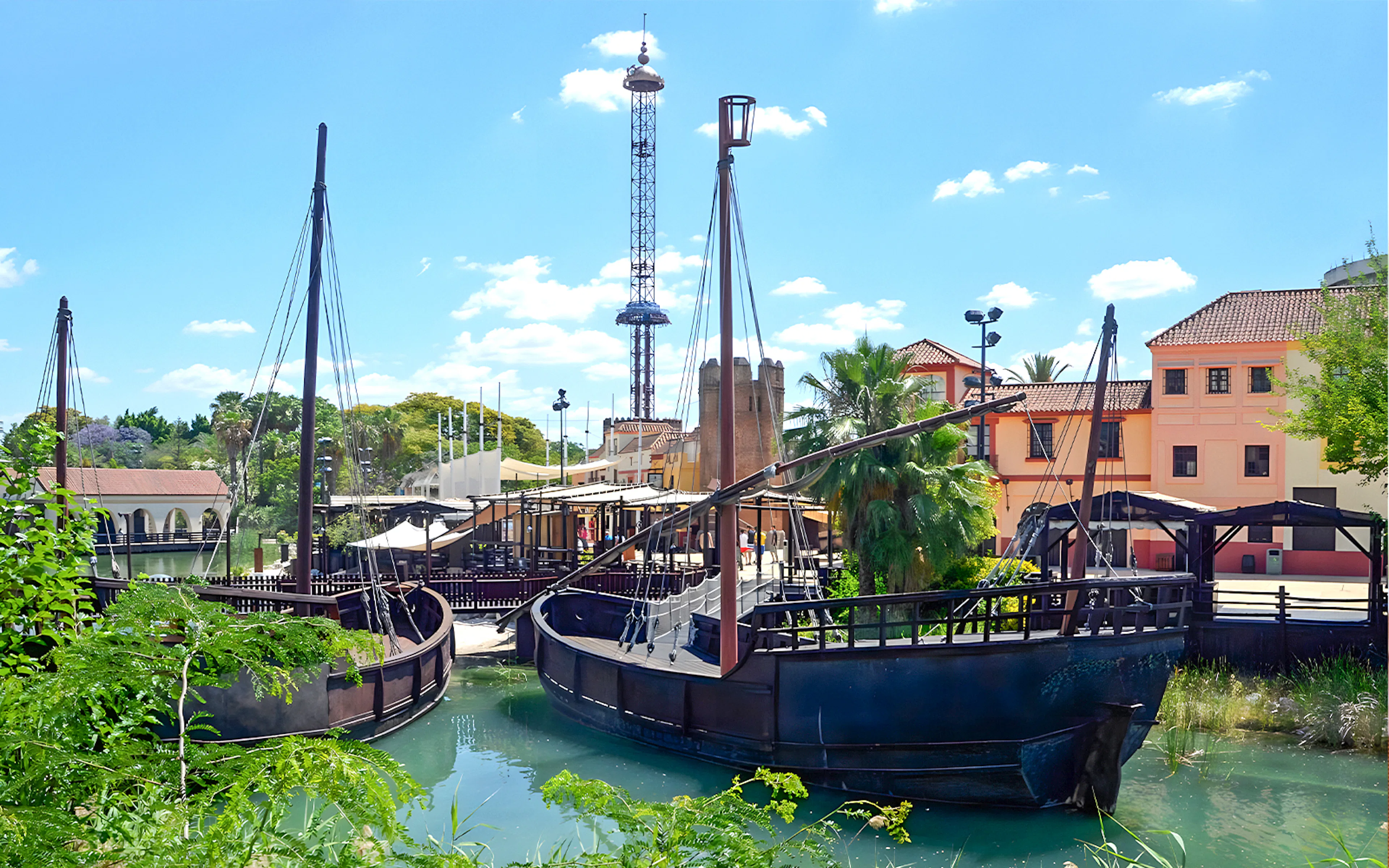 Sevilla's Puerto de Indias at Isla Magica theme park with vibrant water features.