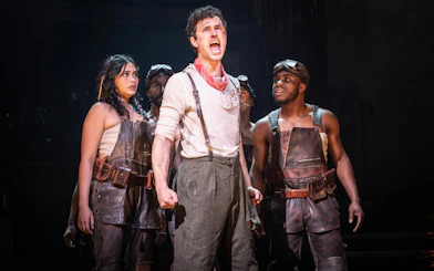 Performers on stage during Hadestown musical in West End.